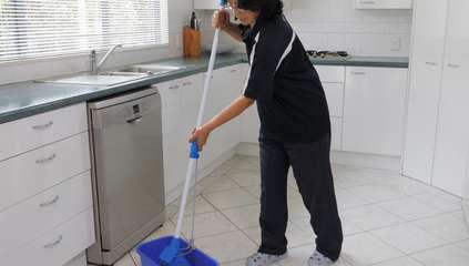 Cleaner mopping the kitchen floor